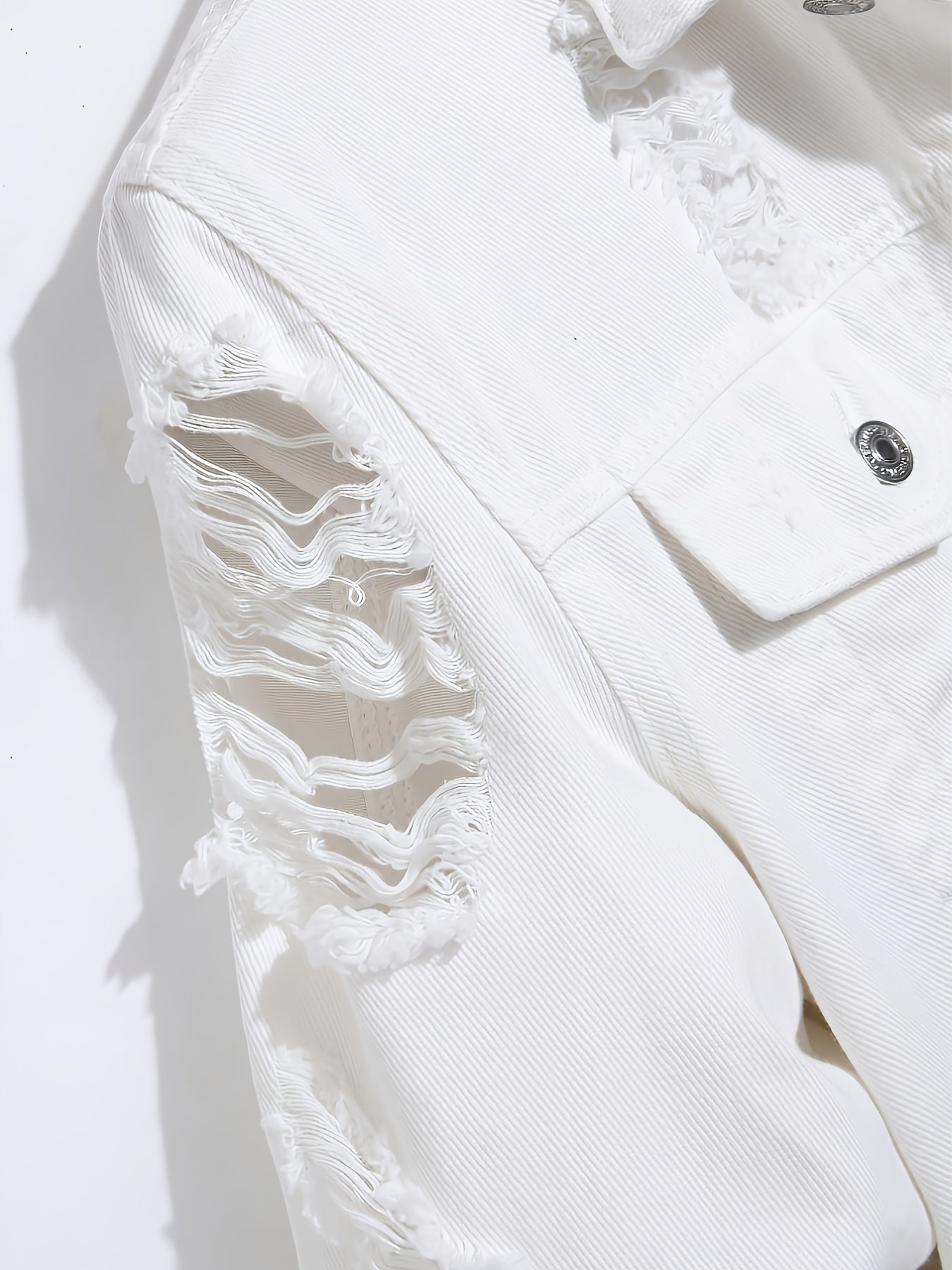 A Straightforward And Stylish Denim Jacket for Men, Featuring a Clean White Minimalist Design, Robust Washed Irregular Perforations, a Relaxed Fit for Added Comfort, a Single-Row Button Closure with an Open Front, And a Trendy, Cool Aesthetic