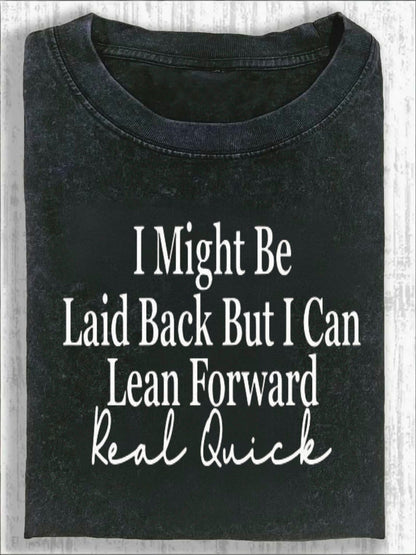 Unisex Crew Neck T-shirt, with Bold Cursive Prints Of White Text On The Front: "I Might, " "Leisurely But I Can, " "Lean Forward Quickly, " And "Really Fast." Fashionable And Casual T-shirt Against A Light Wood Grain Background.