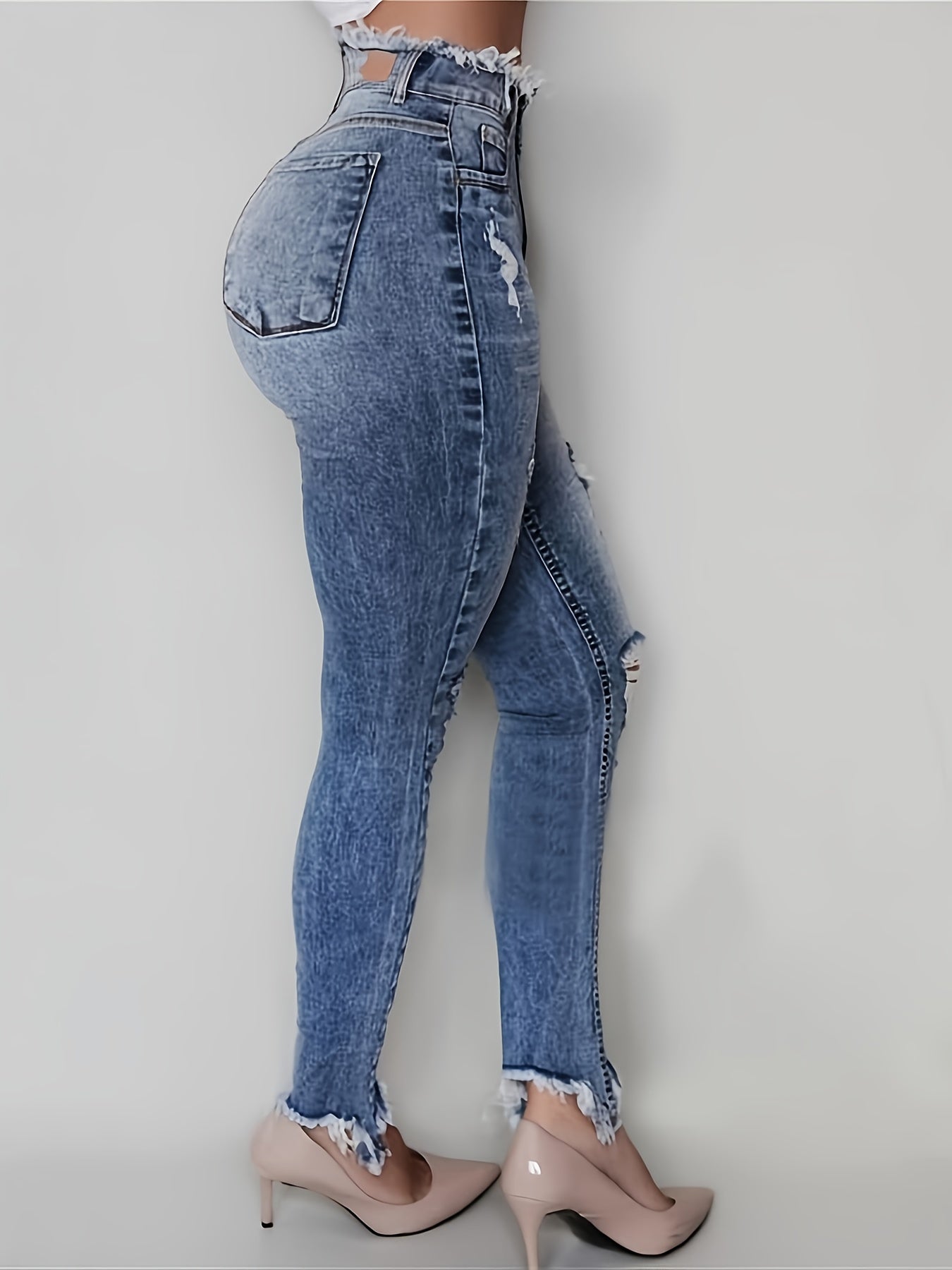 Irregularly Ripped Jeans for Women, Mid-Rise Style, Blue Denim, Featuring a Frayed Edge Design. A Classic And Versatile Choice for Any Season, Part of The New Autumn Collection with Fresh Stock from Local Warehouses. Available at Prices