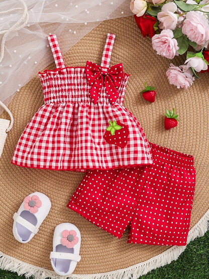 Set of 2 Girls' Outfits for Spring And Summer: a Gingham Dress with a Strawberry Print And Bow, Paired with Red Polka Dot Shorts. This Casual Set Is Machine Washable And Ideal for Toddlers, Featuring a Comfortable Spandex Design, for Outdoor