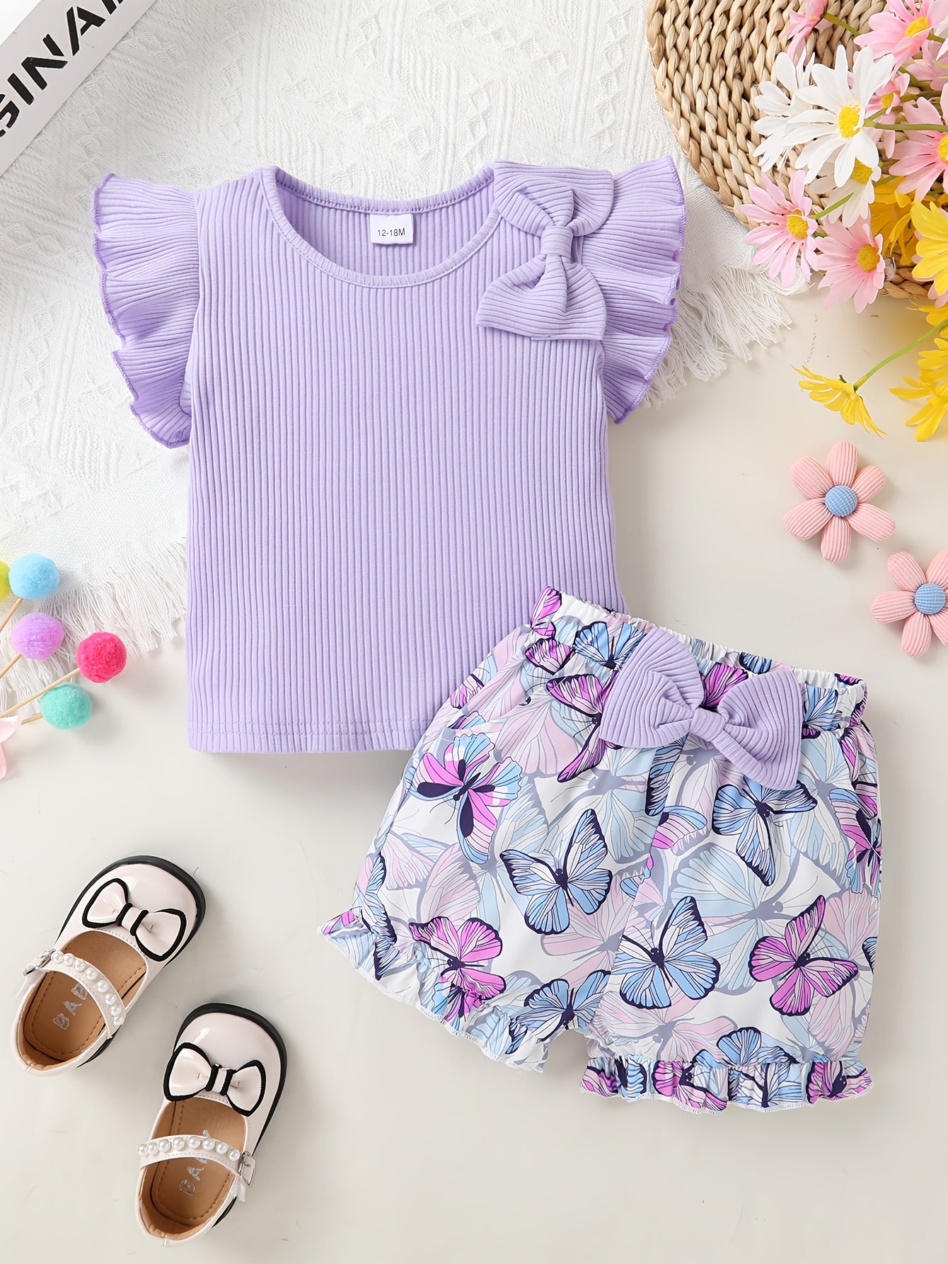 A Charming Two-Piece Outfit Featuring Delightful Details for Young Girls, Including a Ruffled Top with Butterfly Bows And Butterfly-Patterned Shorts, Perfect for Summer Outings And Festive Occasions, for Outdoor