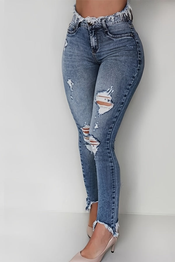 Irregularly Ripped Jeans for Women, Mid-Rise Style, Blue Denim, Featuring a Frayed Edge Design. A Classic And Versatile Choice for Any Season, Part of The New Autumn Collection with Fresh Stock from Local Warehouses. Available at Prices