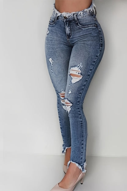 Irregularly Ripped Jeans for Women, Mid-Rise Style, Blue Denim, Featuring a Frayed Edge Design. A Classic And Versatile Choice for Any Season, Part of The New Autumn Collection with Fresh Stock from Local Warehouses. Available at Prices
