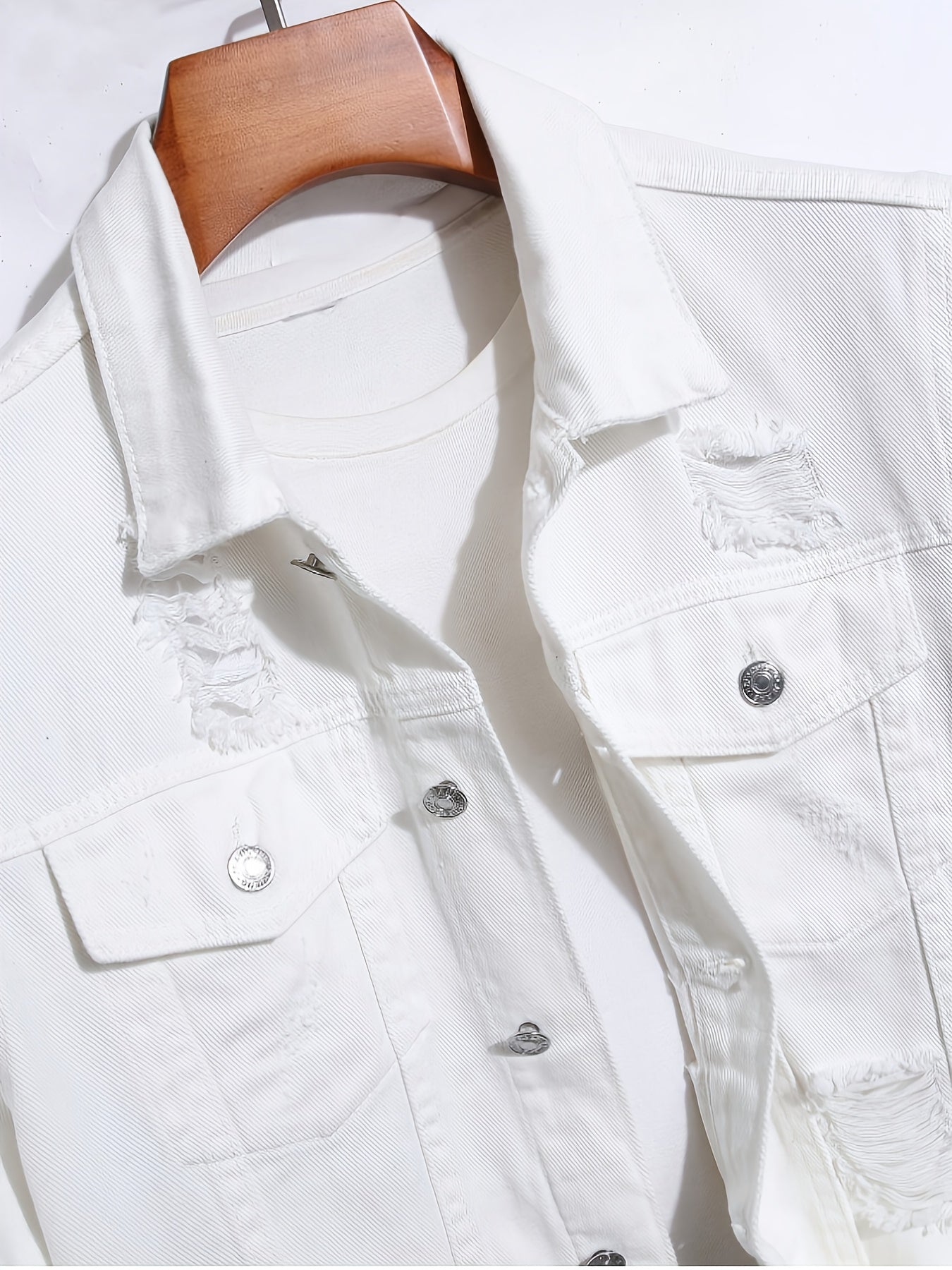 A Straightforward And Stylish Denim Jacket for Men, Featuring a Clean White Minimalist Design, Robust Washed Irregular Perforations, a Relaxed Fit for Added Comfort, a Single-Row Button Closure with an Open Front, And a Trendy, Cool Aesthetic