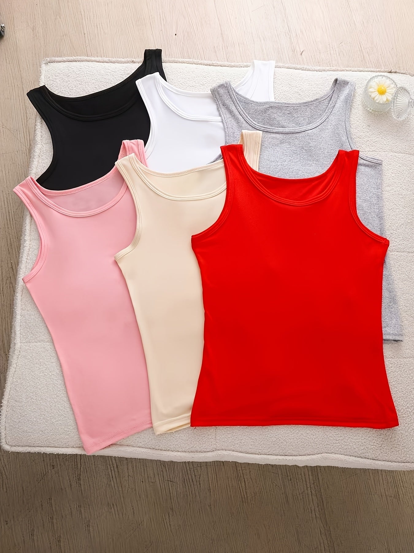 A Set of Six Women'S Soft Adhesive Vests in Various Colors Including Black, White, Gray, Pink, Rose Red, And Green. These Sleeveless Shirts Are Elastic, Breathable, And Comfortable for All Seasons, Making Them Ideal for Home And Casual Outings